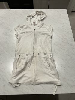 White hooded zip-up vest with pockets and drawstrings.