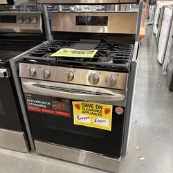 Play pen with baby clothes and baby bottles