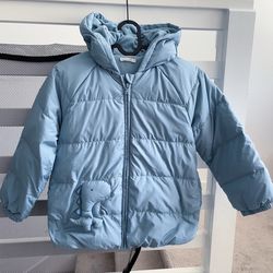 Warm light blue puffer jacket for your little one. Has cozy fleece-lined hood and super cute dinosaur detail on front. This Love Abella jacket is size