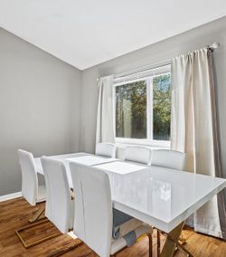 Matching white acrylic dining table and faux leather chairs