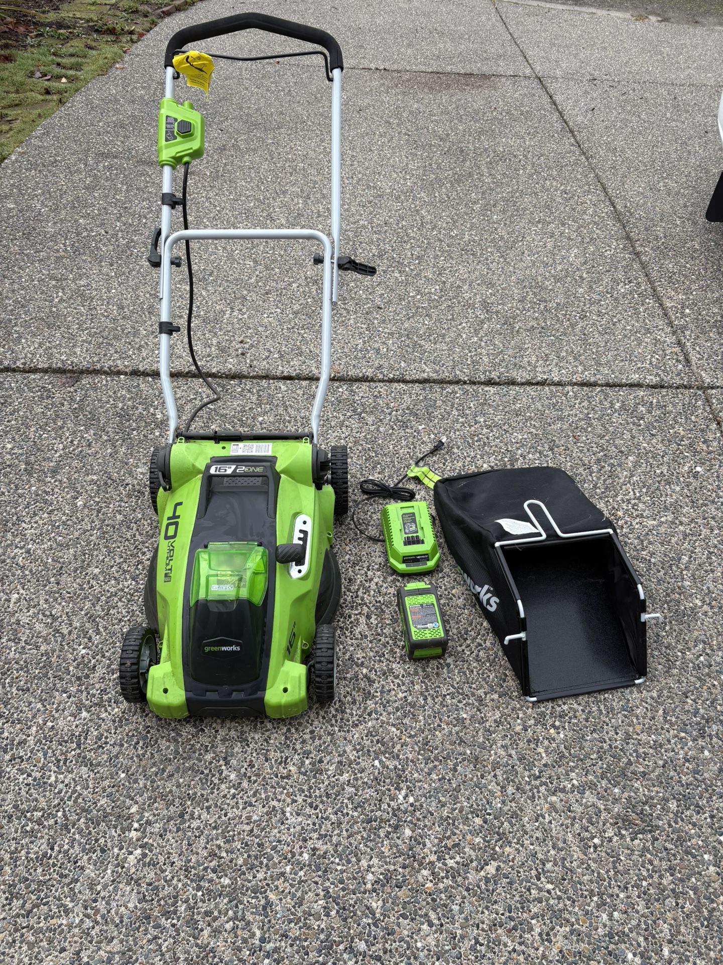 Green works electric cordless lawn mower with free electric weed eater.