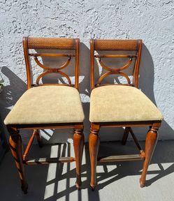 Pair of tall wooden bar stools with padded seats