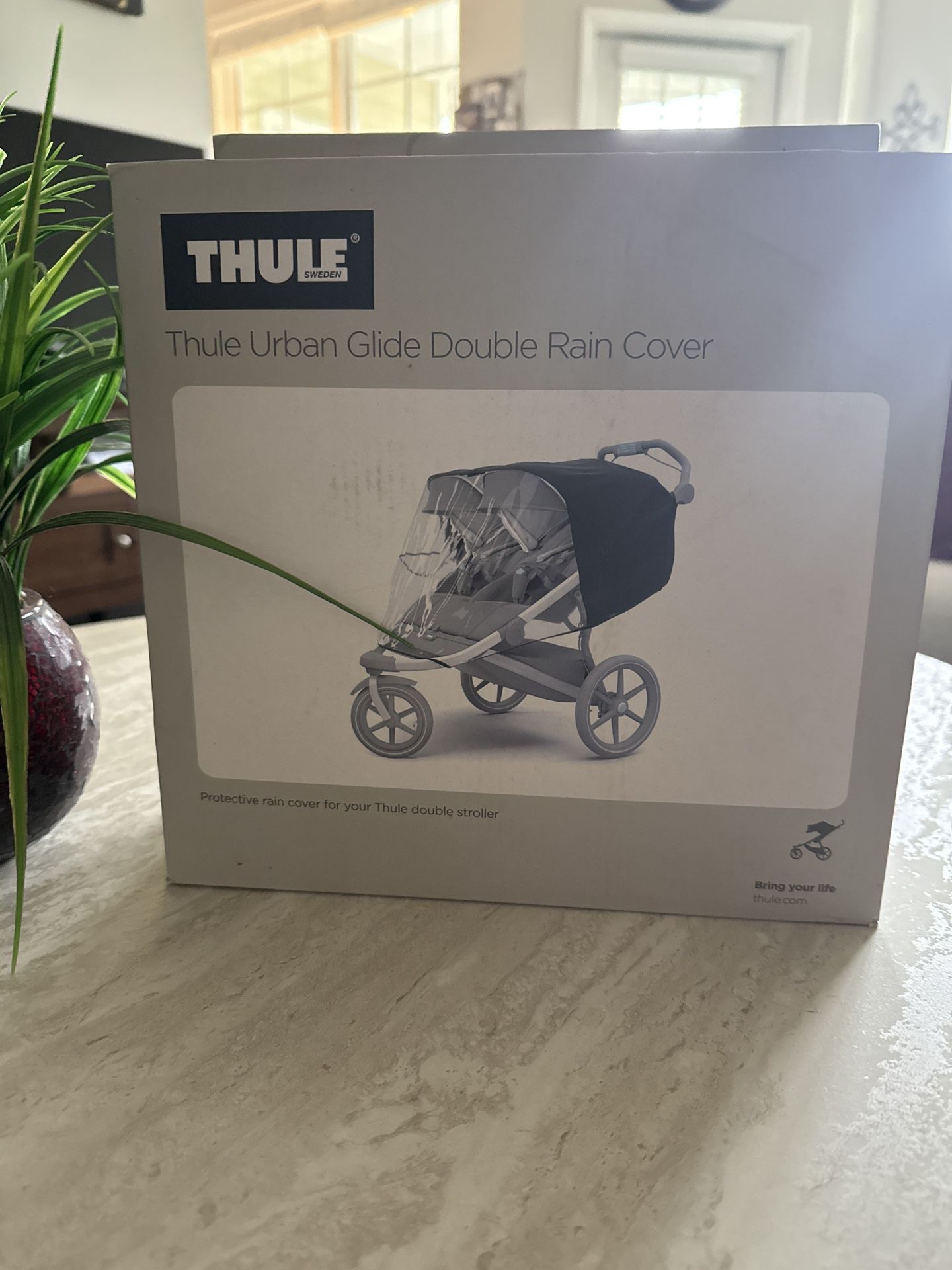 Protective rain cover for Thule double stroller.