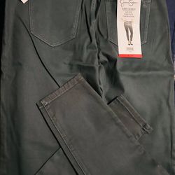 Jessica Simpson Ladies Coated Denim Super Skinny Mid Rise Jeans in a dark green or "Forest Green" color. They are size 8/29. 