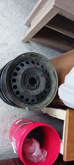 Two stock Nissan Versa Note hatchback rims