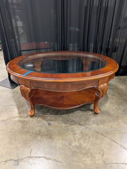 Traditional Reddish-Brown Oval Coffee Table with Glass Top
