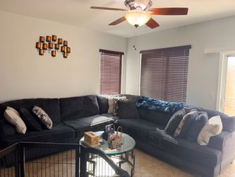 Large Dark Gray  Bluish Fabric Sectional Sofa With Several Pillows