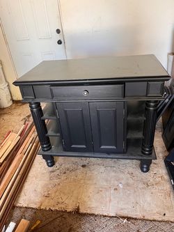 Homestyle Americana Black Kitchen Island featuring a black finish, a central drawer, a two-door lower cabinet, and open sid