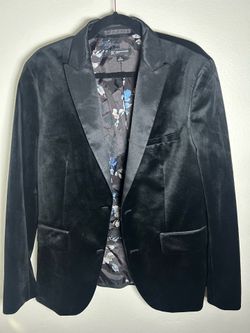 Slim-fit black velvet blazer with satin lapels.