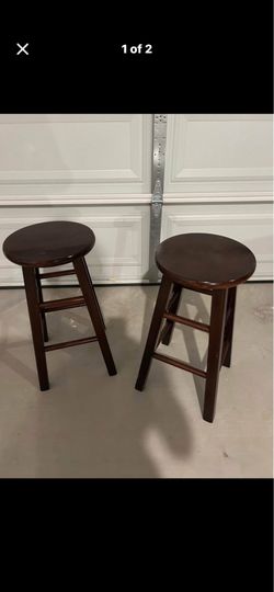 2 brown counter stools