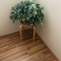 IKEA brand end table with basket and fake plant. Table measures 13”Diameter and 18” Tall. 