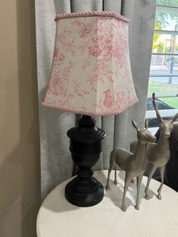 Black table lamp with pink toile shade