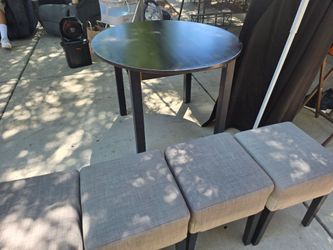 Round Black Wood Dining Table with Four Gray Stools