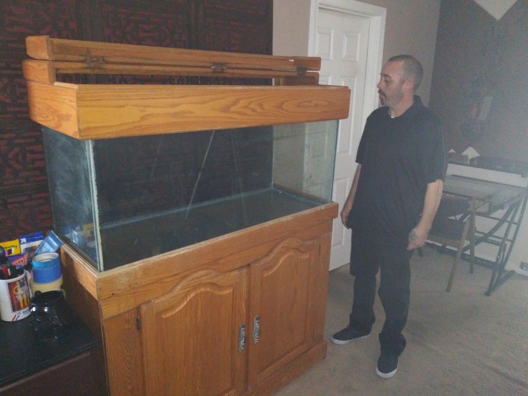 100 gallon fish tank and full salt water system cabinet with lights. Coral rock as well.