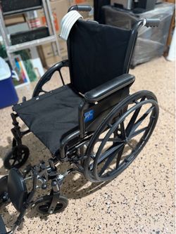 Medline wheelchair with swing back desk, length arms, and elevating leg rests