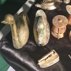 pair of vintage brass swan figurines, likely dating back to the mid-20th century. These decorative pieces could have been used as: 