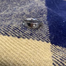 Love Ring features the iconic design with diamond accents. A timeless piece of luxury jewelry!