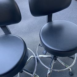 Two Black Swivel Chairs.