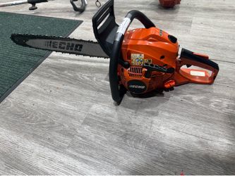 ECHO CS-490 Gas-Powered Rear-Handle Chainsaw sitting on a wood-laminate floor.
