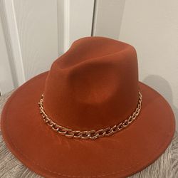 A dark Orange cowgirl Hat 