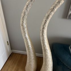 Two tall decorate horns off white