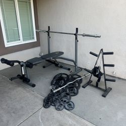 Bench press with 7ft 45lbs bar plus 255lbs of Olympic weights and curl bar and weights tree