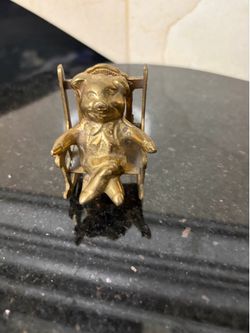 Vintage brass pig in a rocking chair