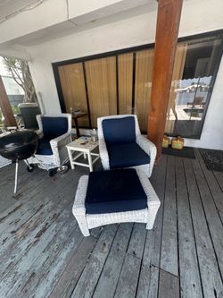 Two piece white wicker outside furniture.