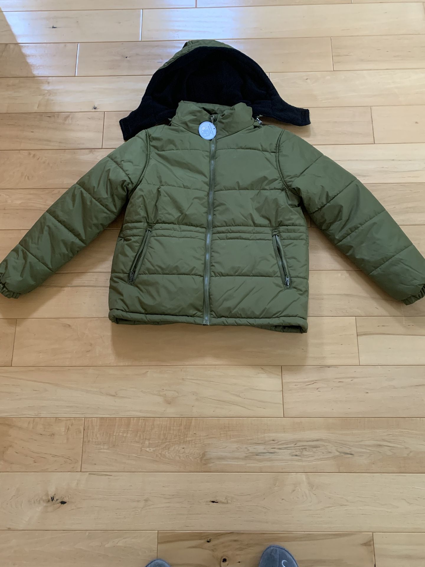 Green coat . Medium size . new .