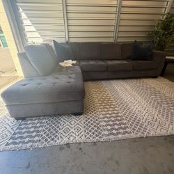 Ashley Furniture Maier two-piece chaise sectional in charcoal gray.  Dimensions:  * Approximately 117″ W × 88″ D × 38″ H * Left-side chaise when facin