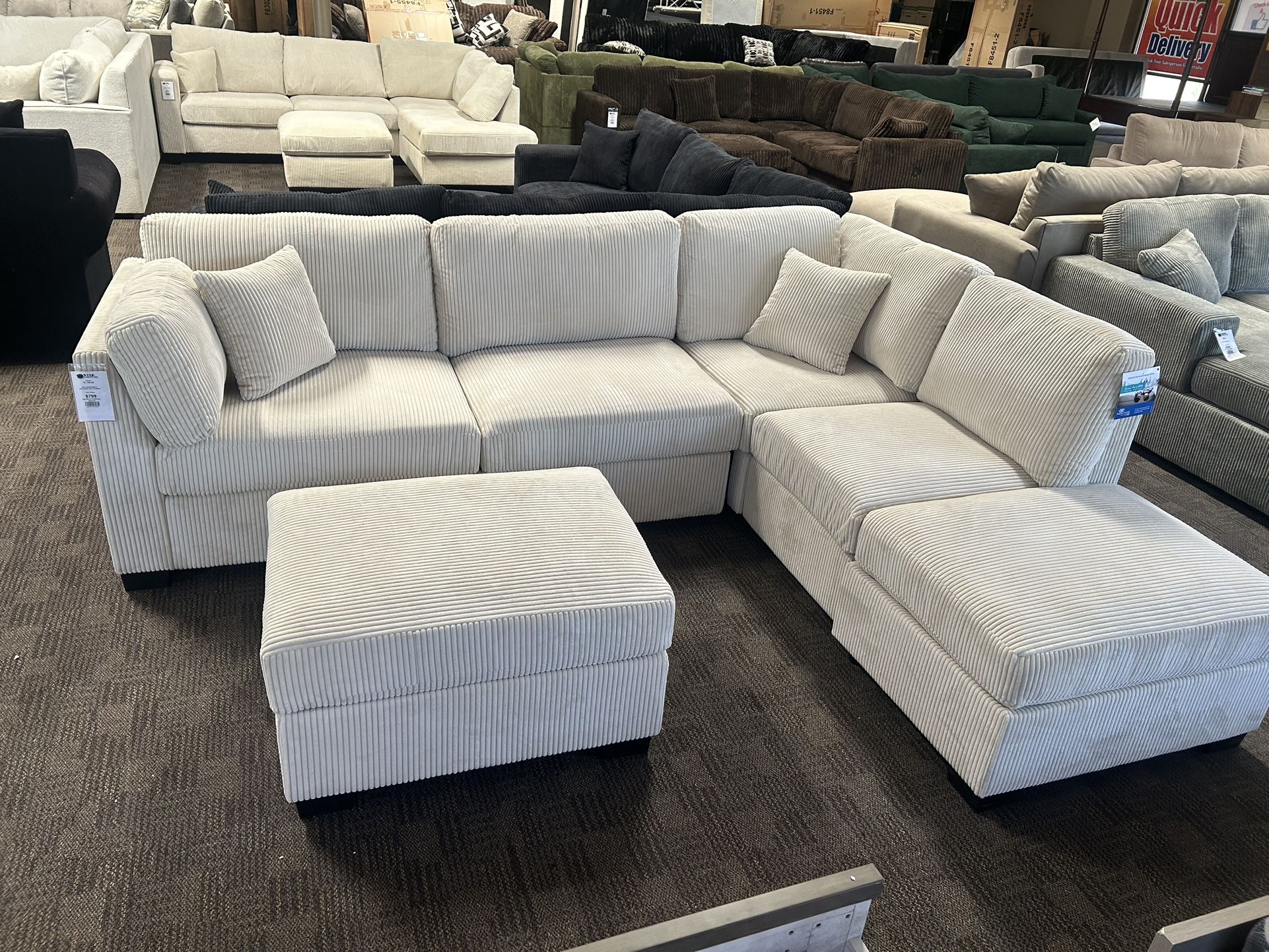 Cream Reversible Chaise Sectional And Ottoman
