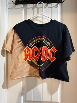 Black and tan mineral-washed AC/DC crop top featuring a bold "High Voltage Rock N' Roll 1976" graphic logo