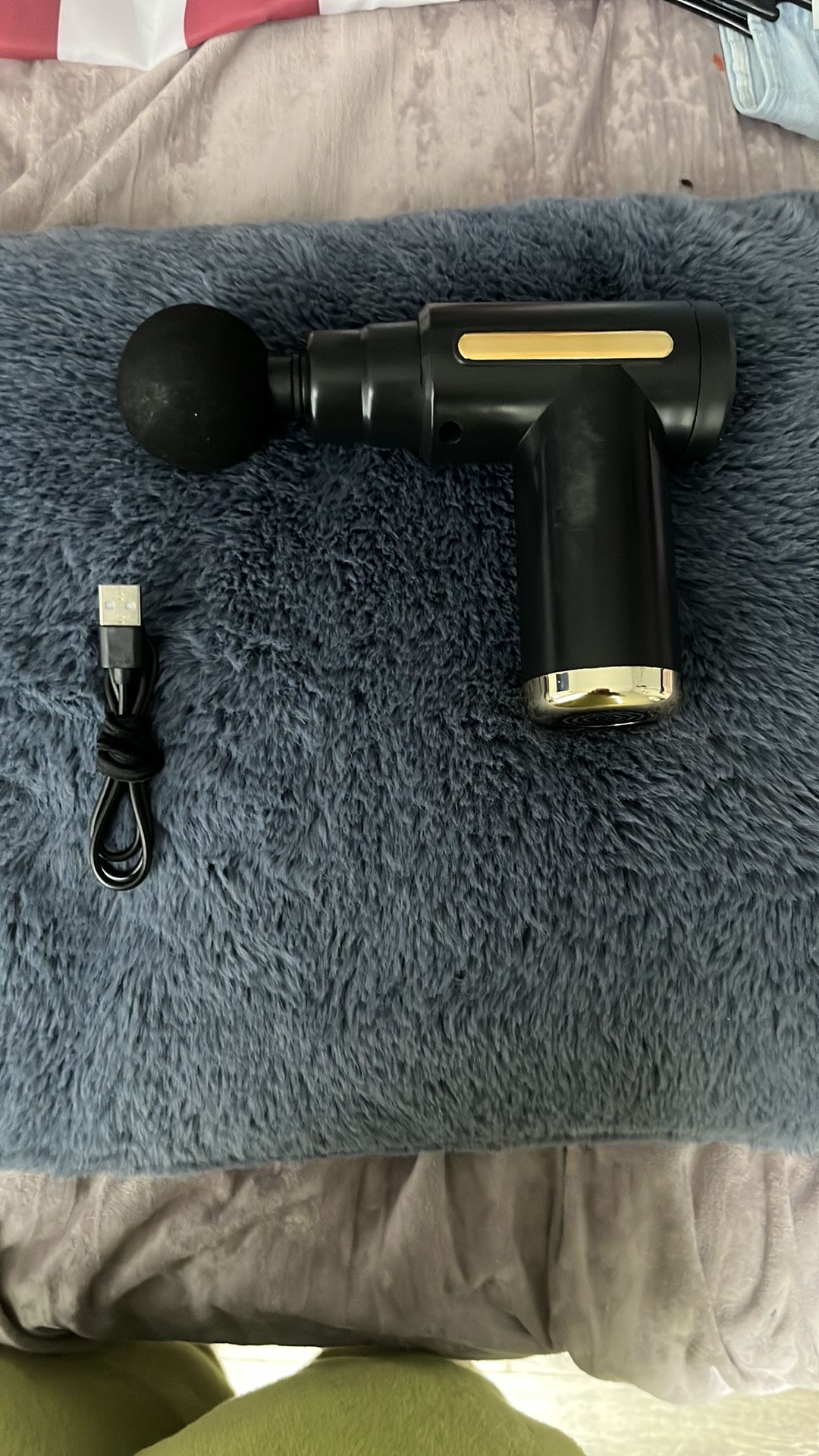 black and gold massage gun