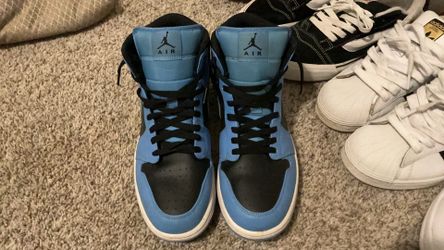 Nike Air Jordan 1 Mid University Blue Black sneakers.
