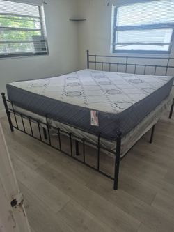 Black metal king size bed with mattress