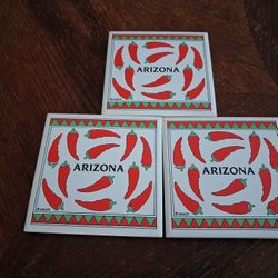 Ceramic tile coasters featuring a red chili pepper design