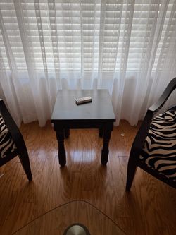 Accent chairs with small black table and coffee table
