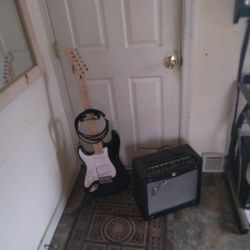 Left Hand Fender Squire Stratocaster Guitar And Amplifier Combo.