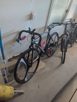 Black and Red Road Bike with Tri-Spoke Wheels
