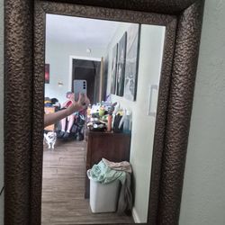 Wall mirror with metal frame.
