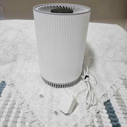 Mini  air purifier with a filter. It is designed to improve air quality by removing dust, allergens, odors, and some gases from the air. 