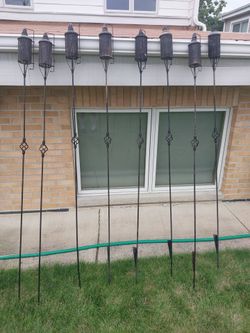 Eight Wrought Iron Tiki Torches + Fuel