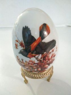 Red Stripe Bird flying down an Autumn Tree.