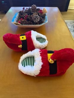 Festive red and white Santa Claus slippers with bell accents. One size fits all. Like new.