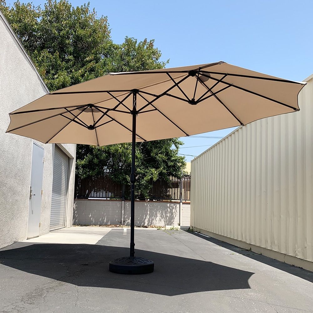 $130 (New) Large 15 ft double sided outdoor umbrella with 65 lbs plastic weight base (beige color) 