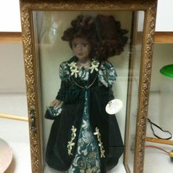 Black 16" porcelain doll in gold case 21x11x7