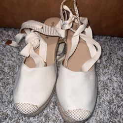 Cream-colored espadrille wedge sandals with ankle ties, size 9