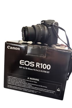 Canon R100 with 18-45mm lens.