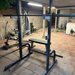 Squat rack, bar, weights 246 pounds , tree and benches plus extra 25 lb plate and Olympic curling bar