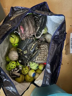 Bag of old softball and baseball equipment
